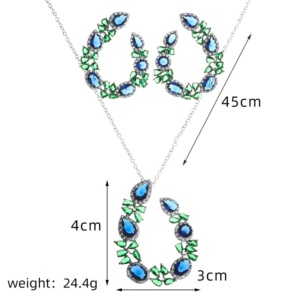 Jewelry set with green and blue gemstones, including necklace and earrings, with measurements on a white background.