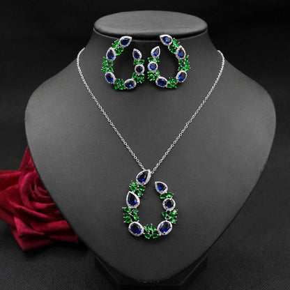Jewelry set with necklace and earrings on a black mannequin bust.